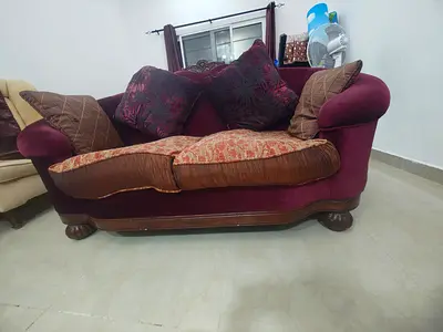 Used 2-seater maroon fabric sofa with cushions - good condition