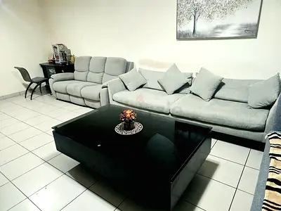 Urgent selling Complete Living Room Set – 2 Sofas + Large Glass Coffee Table | AED 1,499