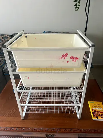 White metal storage organizer with drawers and wire shelves