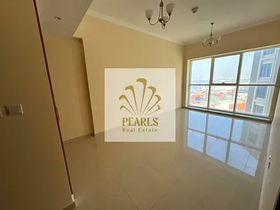 Luxury 2-master BR apartment for annual rent in Ajman, Liwara 1 near Corniche. Spacious hall, 3 baths, balcony & FREE central A/C! Only 50k.