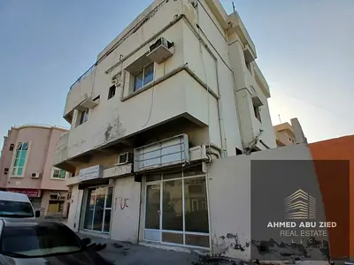 **An excellent investment opportunity in Liwara, Ajman: A two-level property (ground floor plus one upper floor) featuring four 2-bedroom apartments a