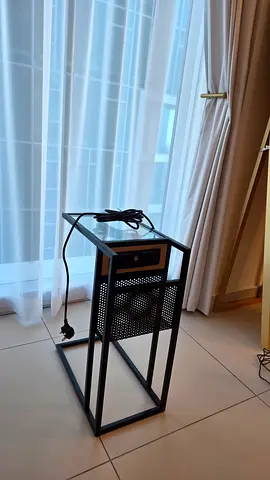 Black metal side table with built-in power strip - good condition