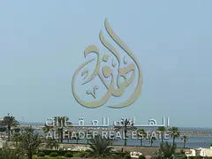A 3-bedroom apartment with a living room in Al-Qulai'a, featuring a sea view and a balcony. It inclu
