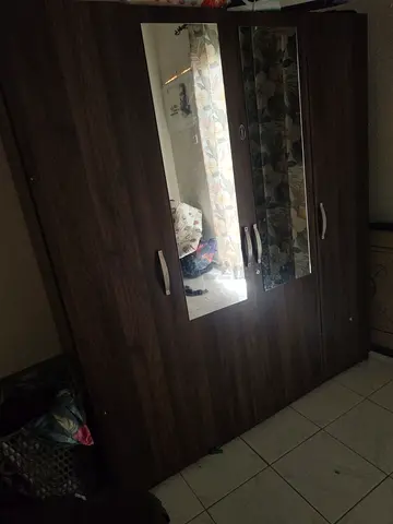 4‑door dark wood wardrobe with mirror — good condition