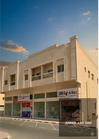 **An investment opportunity in Al Muwaihat 2, Ajman: A residential-commercial building featuring 15