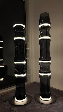Pair of modern black glass LED floor lamps — sculptural column design