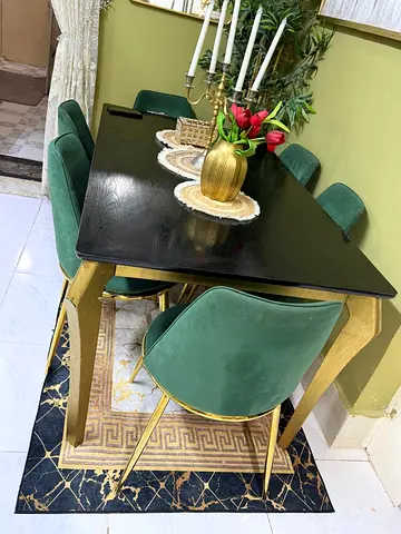 Modern black dining table with 6 green velvet chairs