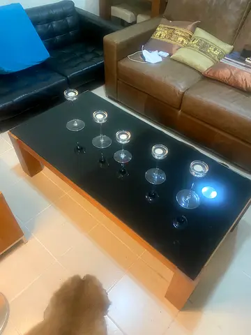 Indigo Living walnut wood coffee table with black glass top - good condition