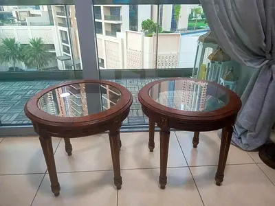 Pair of vintage round wooden side tables with glass top