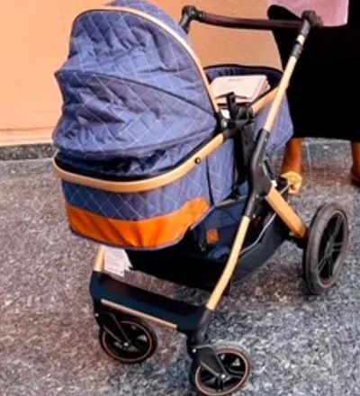 Stylish navy quilted pram stroller with bassinet — excellent condition