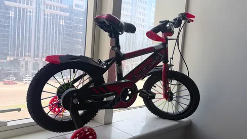 Red kids bicycle with training wheels - 12 inch