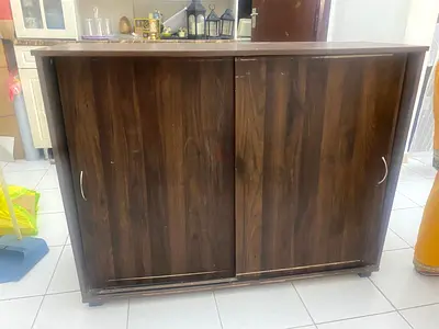 Dark wood sliding door cabinet - good storage, needs minor touch-up