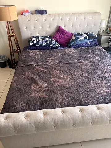 Beige tufted upholstered king-size bed frame with headboard