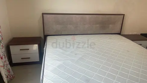 Queen bed frame with mattress and two bedside tables - good condition