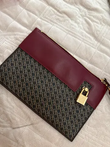 Brown patterned clutch bag with burgundy leather trim and gold padlock