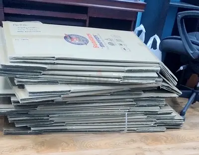 Bundle of flattened cardboard boxes for moving/packing for sale