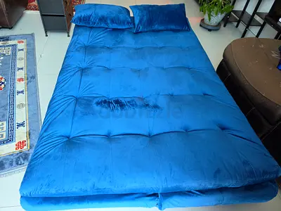 Blue foldable floor mattress / futon with two pillows