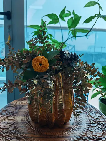 Decorative golden vase with artificial floral arrangement - ready display piece