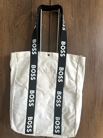 White canvas tote bag with BOSS branded black straps