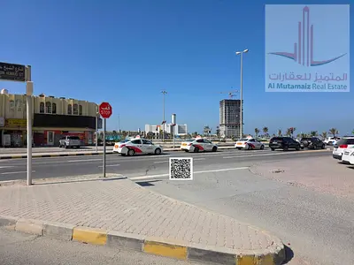 Residential/commercial land for sale on a main street, very prime location, one minute from Ajman Marina and next to Al-Muhtarefeen School.