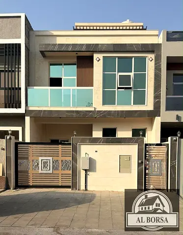 For sale in Al Zahia, Ajman: a 5-bedroom townhouse featuring a majlis and a living area, distributed across the ground floor, first floor, and roof.