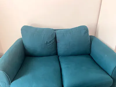 Blue 2-seater sofa in good used condition