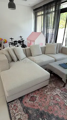 Light grey L-shaped fabric sofa with chaise