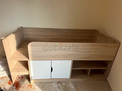Wooden toddler loft bed with built-in storage and shelves - good condition