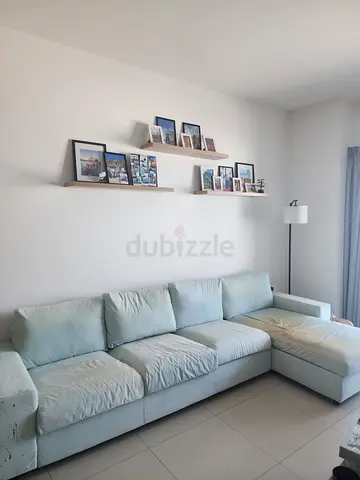 Light blue L-shaped fabric sofa, average condition