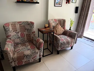 Pair of patterned upholstered armchairs in excellent condition