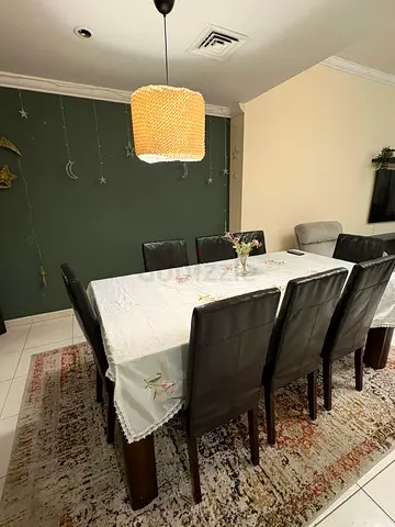 Wooden Dining Table with 8 Dark Leather 7 seater sofa - Good Condition. 1st owner from Pan emirates