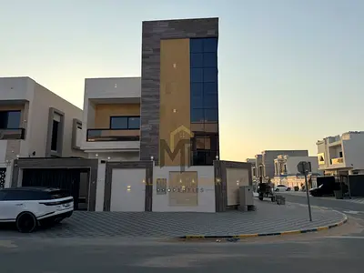 Brand-new corner villa for sale in Al Amerah, Ajman; features 5 master bedrooms, sophisticated design, and spacious interiors—ideal for family living