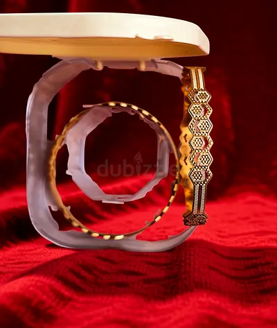 Two gold-tone bangles/bracelets - vintage-style geometric design