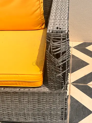 Gray rattan outdoor corner sofa set - damaged corner, cushions included for sale .
