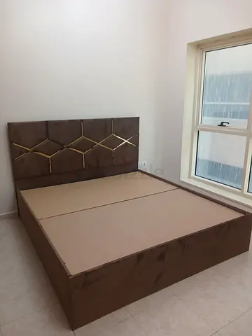 Queen size upholstered bed frame with decorative headboard - brown