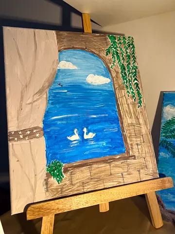 Hand-painted seaside arch canvas painting on easel, ( A drawing reflecting Greek creativity in 2026)