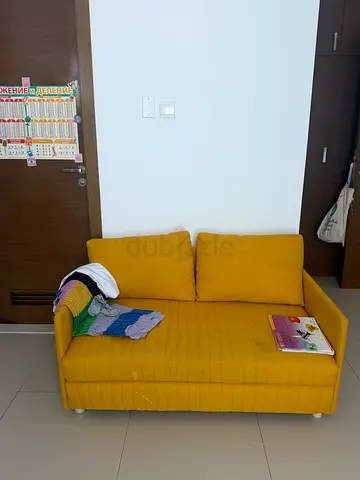 Compact mustard yellow 2-seater sofa in good condition
