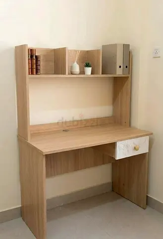 Compact wooden study desk with shelving and drawer