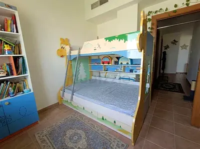 Jungle theme Kids Bunk Bed with removable ladder and storage drawers with built in bookshelf.