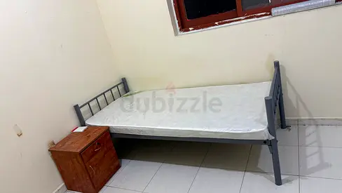 Single metal frame bed with mattress and bedside drawer