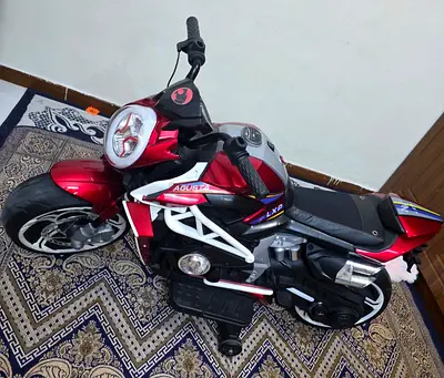 Red electric ride-on motorcycle for kids — good condition