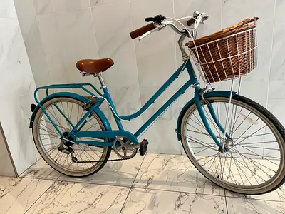 Classic teal city bike with basket — good condition