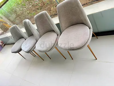 Set of 4 modern grey dining chairs with gold legs. From Westelm