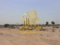 Commercial land for sale in Sharjah, Al-Malha area, next to the Sudan School; available for ownershi