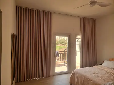 Full-length beige fabric curtains with track - set for bedroom