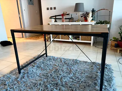 Dining table for four with wood top and metal legs
