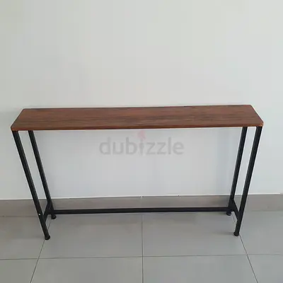Slim industrial console table with wooden top and metal frame.