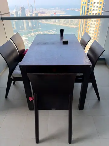 Solid brown dark wood dining table with 4 chairs - good condition