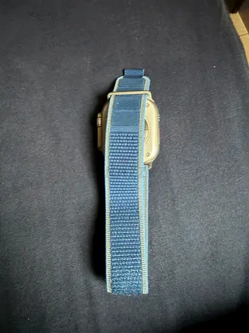 Used smartwatch with blue fabric strap (needs battery)