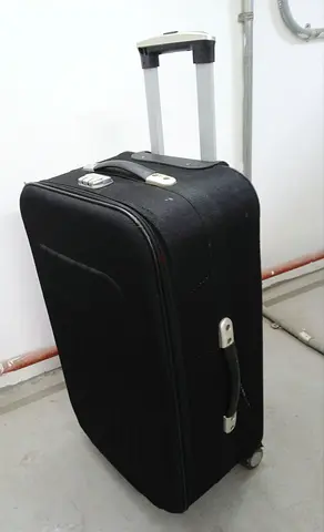 Black medium-sized trolley suitcase with wheels and telescopic handle